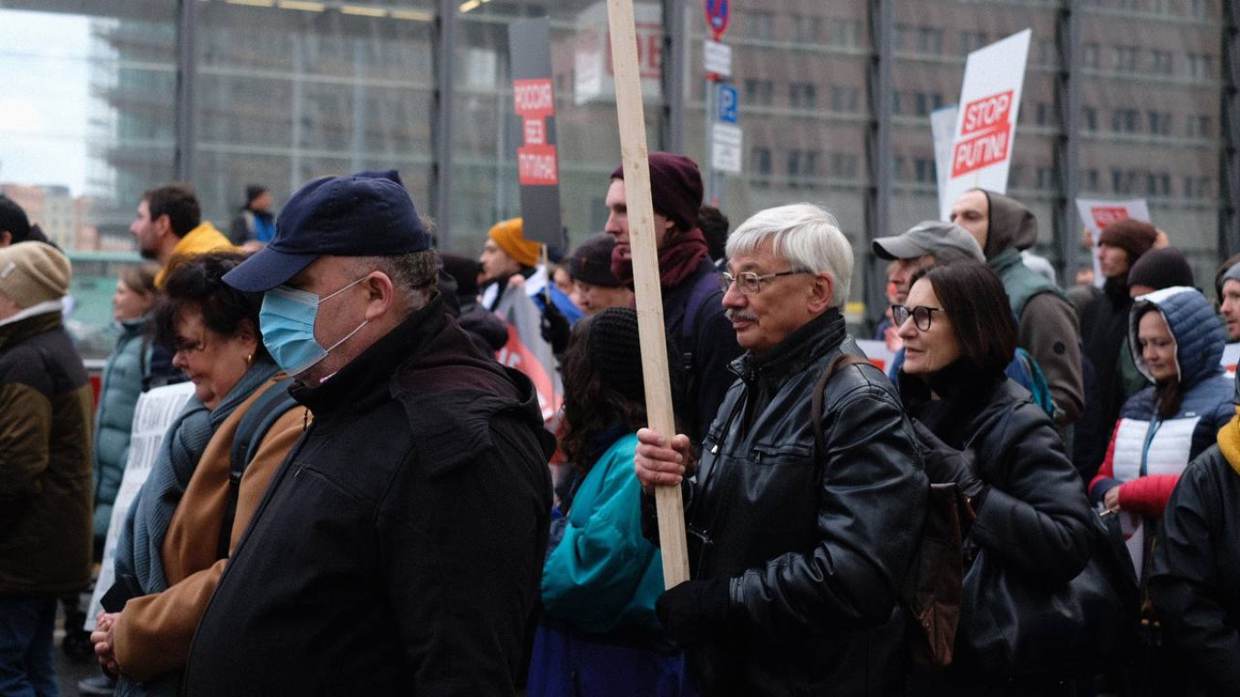 
					Memorial co-chair Oleg Orlov carries a sign at the protest.					 					Moscow Times reporter				