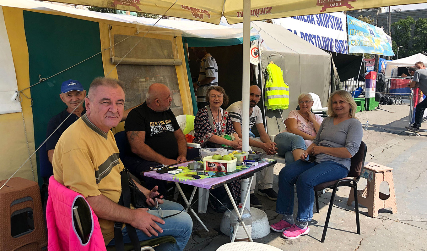 
					A group of protesters sitting near a tent in downtown Belgrade.					 					Leyla Latypova / MT				