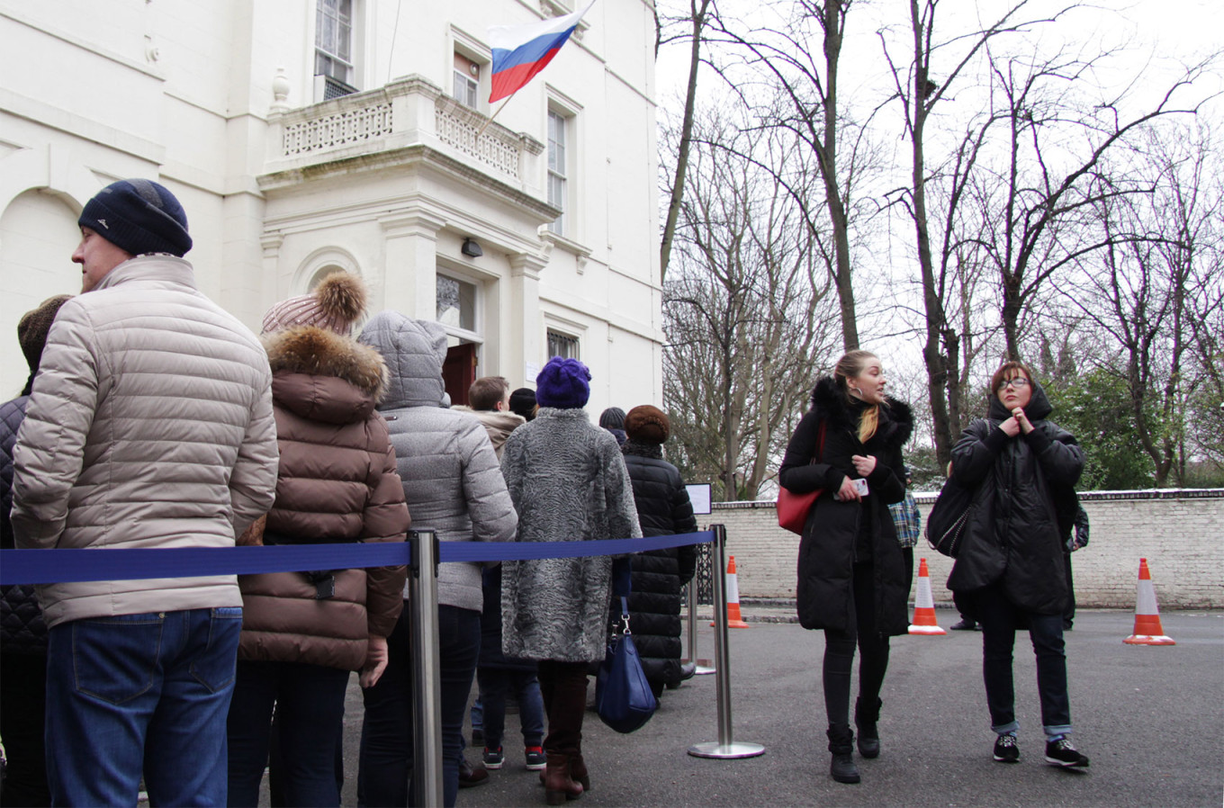 
					Russian citizens queue outside a polling station in the Russian Embassy to vote in the 2018 Russian presidential election in London. 					 					Igor Brovarnik / TASS 				