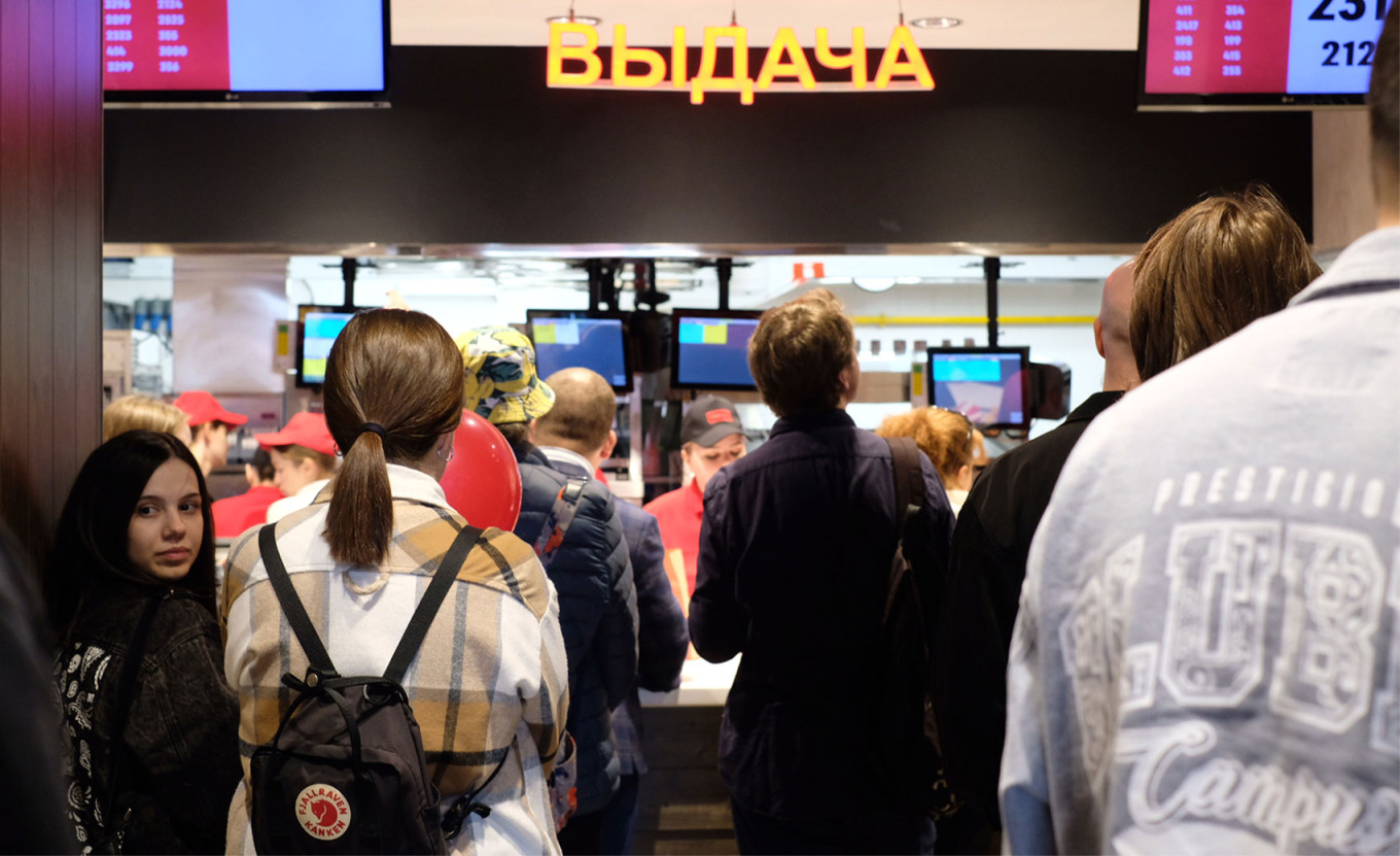 
					Customers wait for their orders at the pick-up counter.					 					MT				