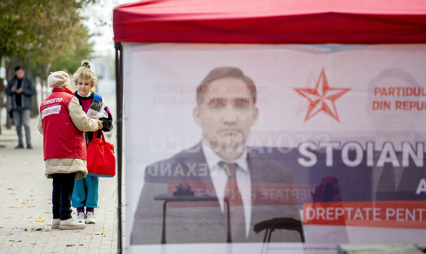 
					A woman hands out election leaflets in downtown Chisinau.					 					Dumitru Doru / EPA / TASS				