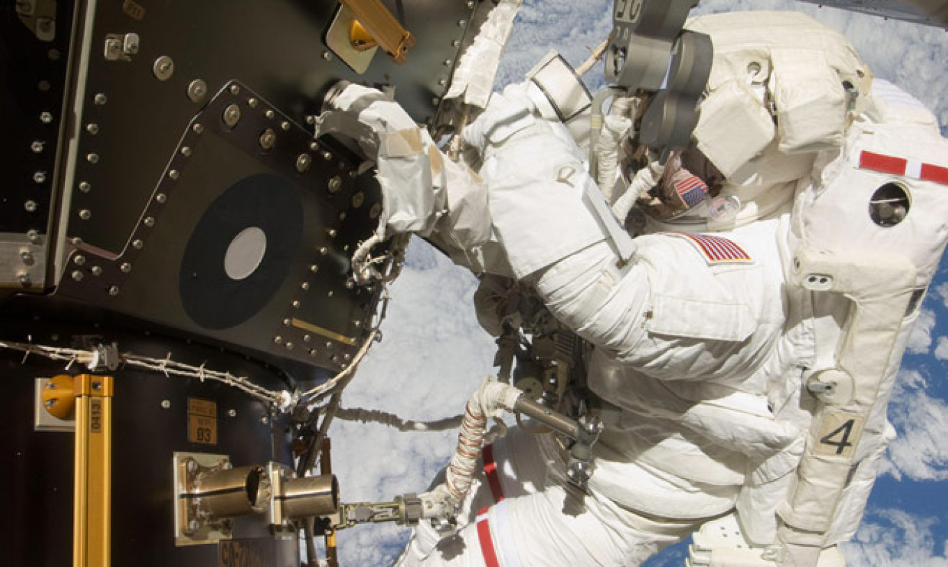 NASA astronaut Mike Hopkins conducting the second of two spacewalks over a four day period in December 2013. NASA