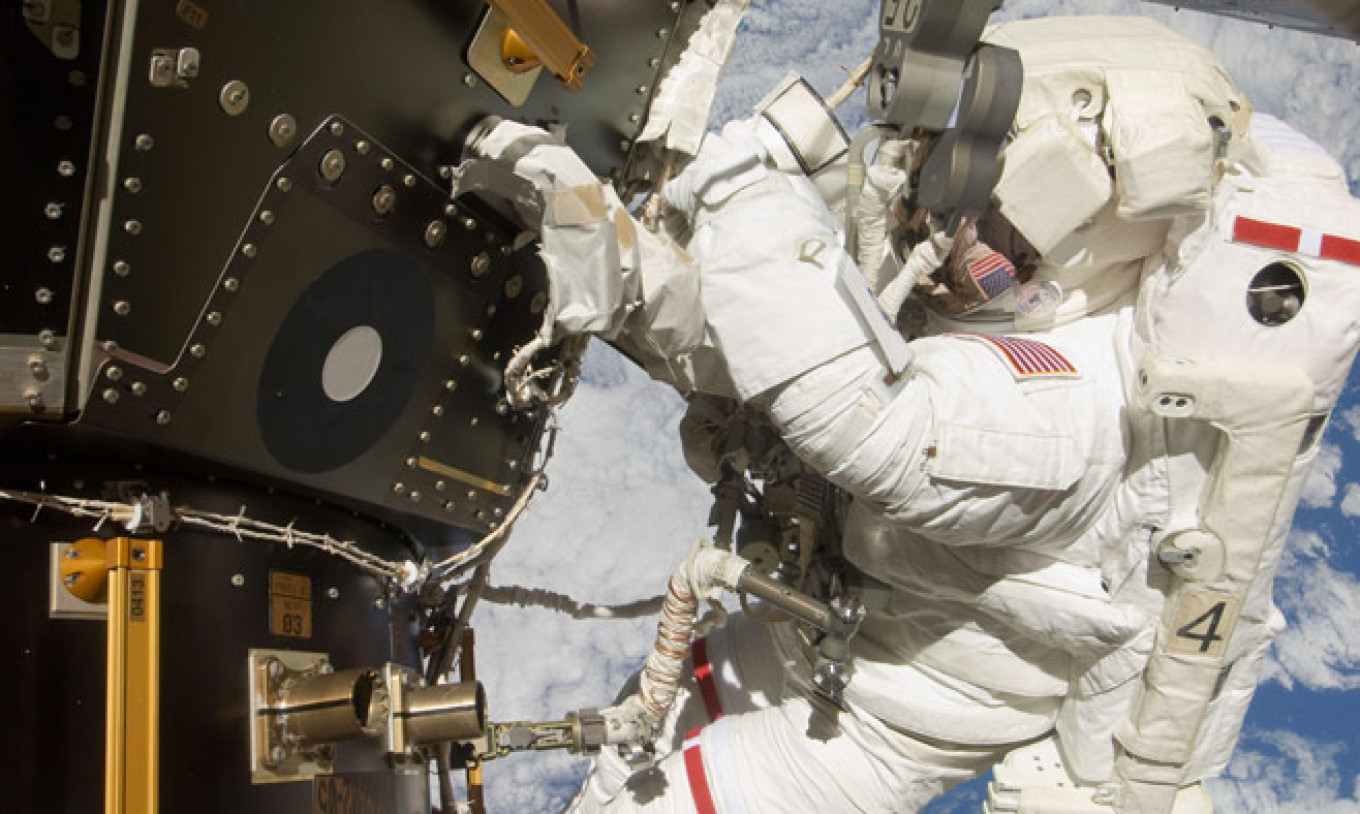 
					NASA astronaut Mike Hopkins conducting the second of two spacewalks over a four day period in December 2013.					 					NASA				