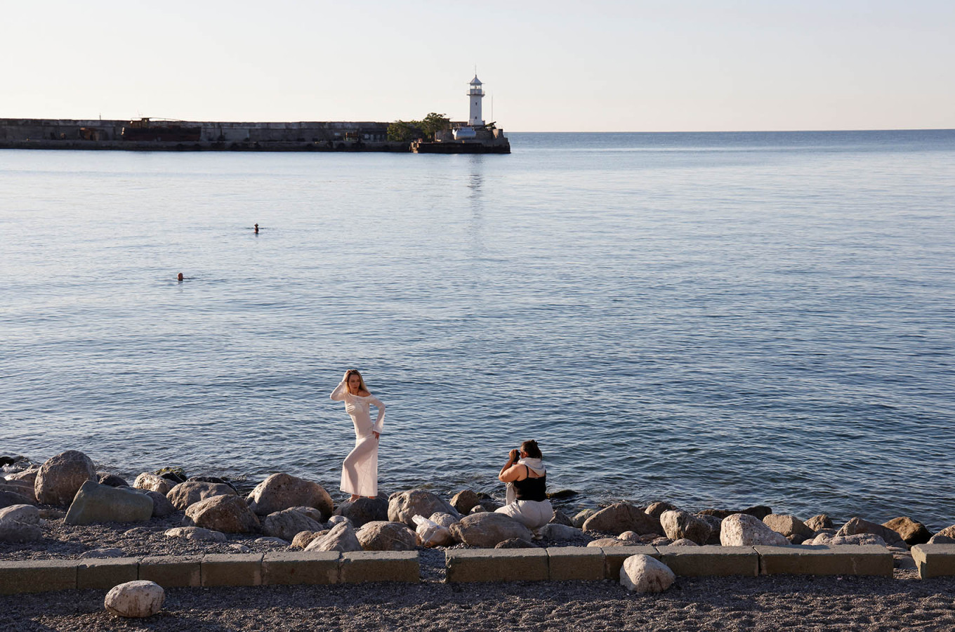 A woman poses for a photo on the beach in the Black Sea resort city of Yalta, annexed Crimea. REUTERS / Alexey Pavlishak