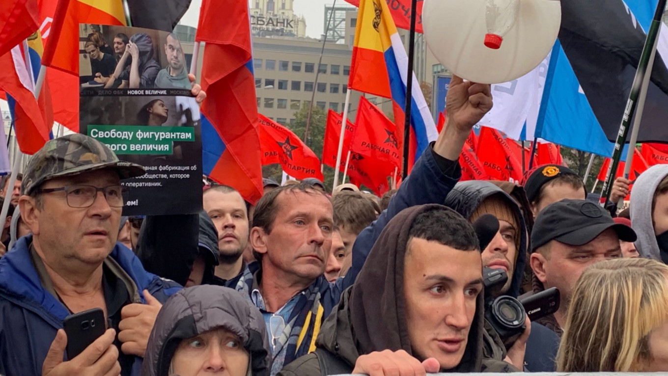 
					A protester in Moscow on Sunday holds up items that served as evidence of violence against police.					 					Evan Gershkovich / MT				