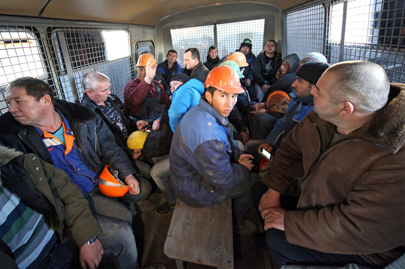 
					Workers at a construction site in Moscow who were detained following a police raid.					 					Moskva News Agency				