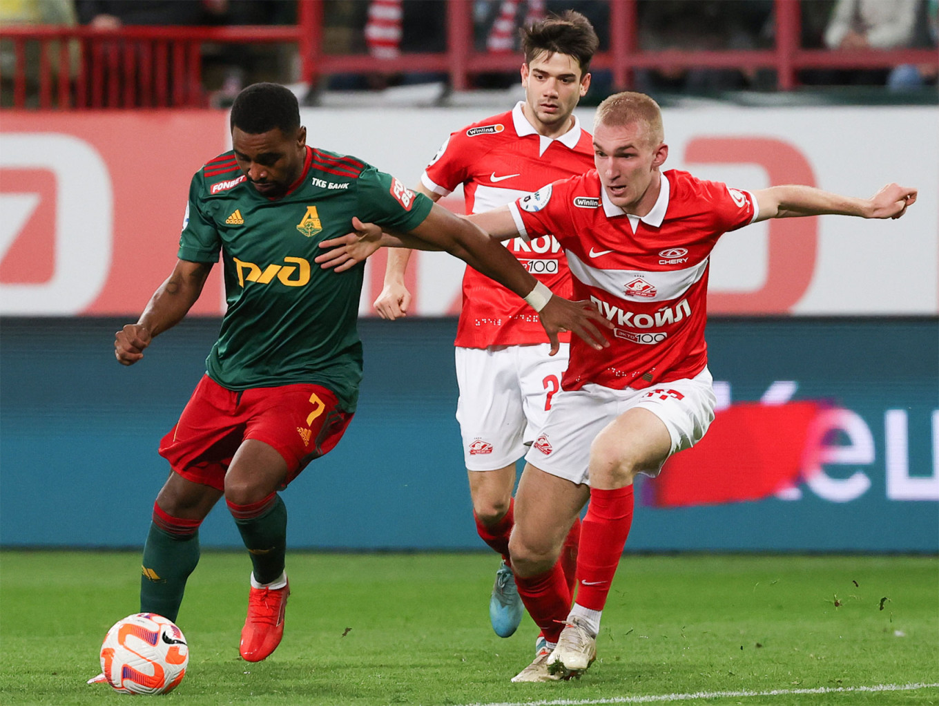 Lokomotiv Moscow's Gyrano Kerk, Spartak Moscow's Danil Prutsev and Daniil Denisov (L-R) in a recent match in Moscow. Anton Novoderezhkin / TASS
