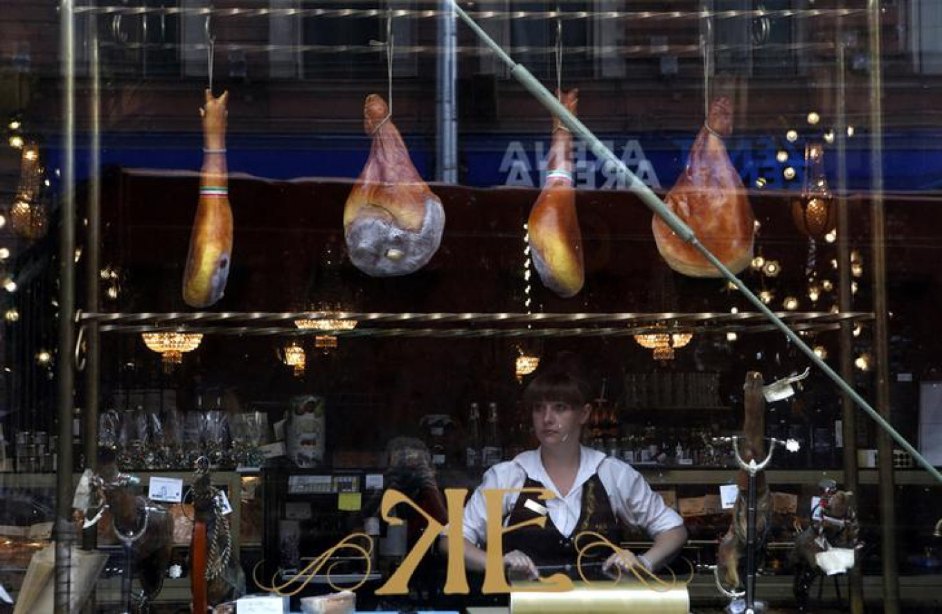 
					Spanish ham is displayed for sale in a shop window at a grocery store in St. Petersburg. Russia stopped imports of most food from the West.					 					Alexander Demianchuk / Reuters				