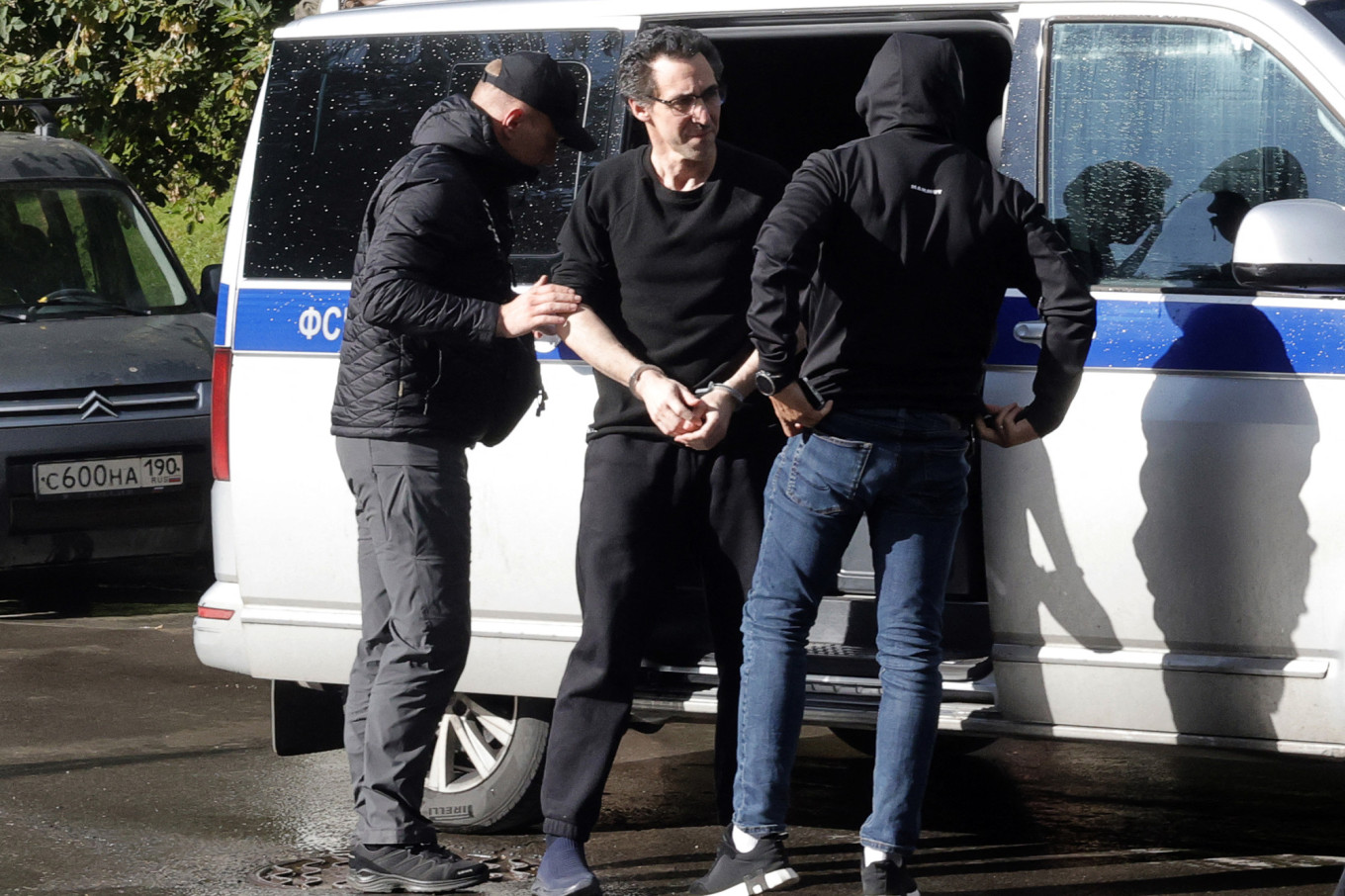 
					Laurent Vinatier (C) being escorted to a court for a hearing related to espionage charges in Moscow on Aug. 25, 2025.					 					Tatyana Makeyeva / AFP				