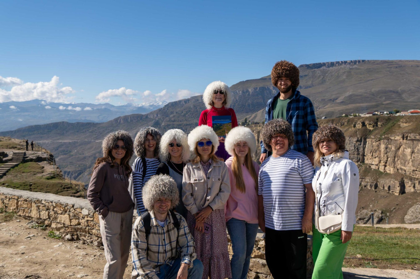 
					Tourists in Dagestan photographed wearing the papakha, a fur hat traditionally worn throughout the Caucasus.					 					season-travel.com				