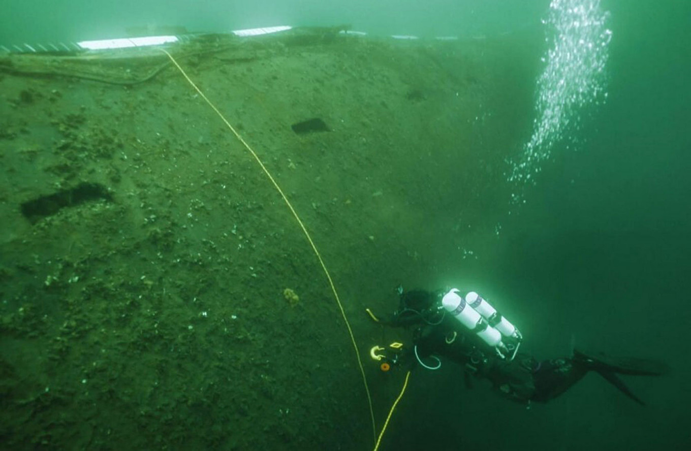 
					A diver examines the hull of the dumped nuclear powered submarine K-27 in the Kara Sea.					 					Center for Underwater Research of the Russian Geographical Society				