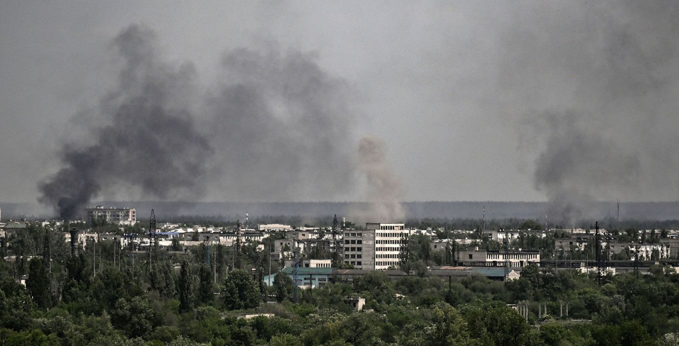 
					Smoke and dirt rise from the city of Severodonetsk during shelling.					 					ARIS MESSINIS / AFP				
