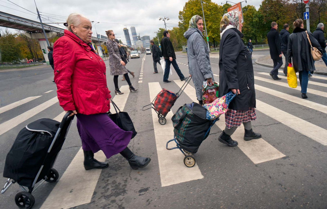 
					A group of women crossing the street at the All-Russia Exhibition Center, where many of them sell food and clothing. 					 					Vladimir Filonov / MT				