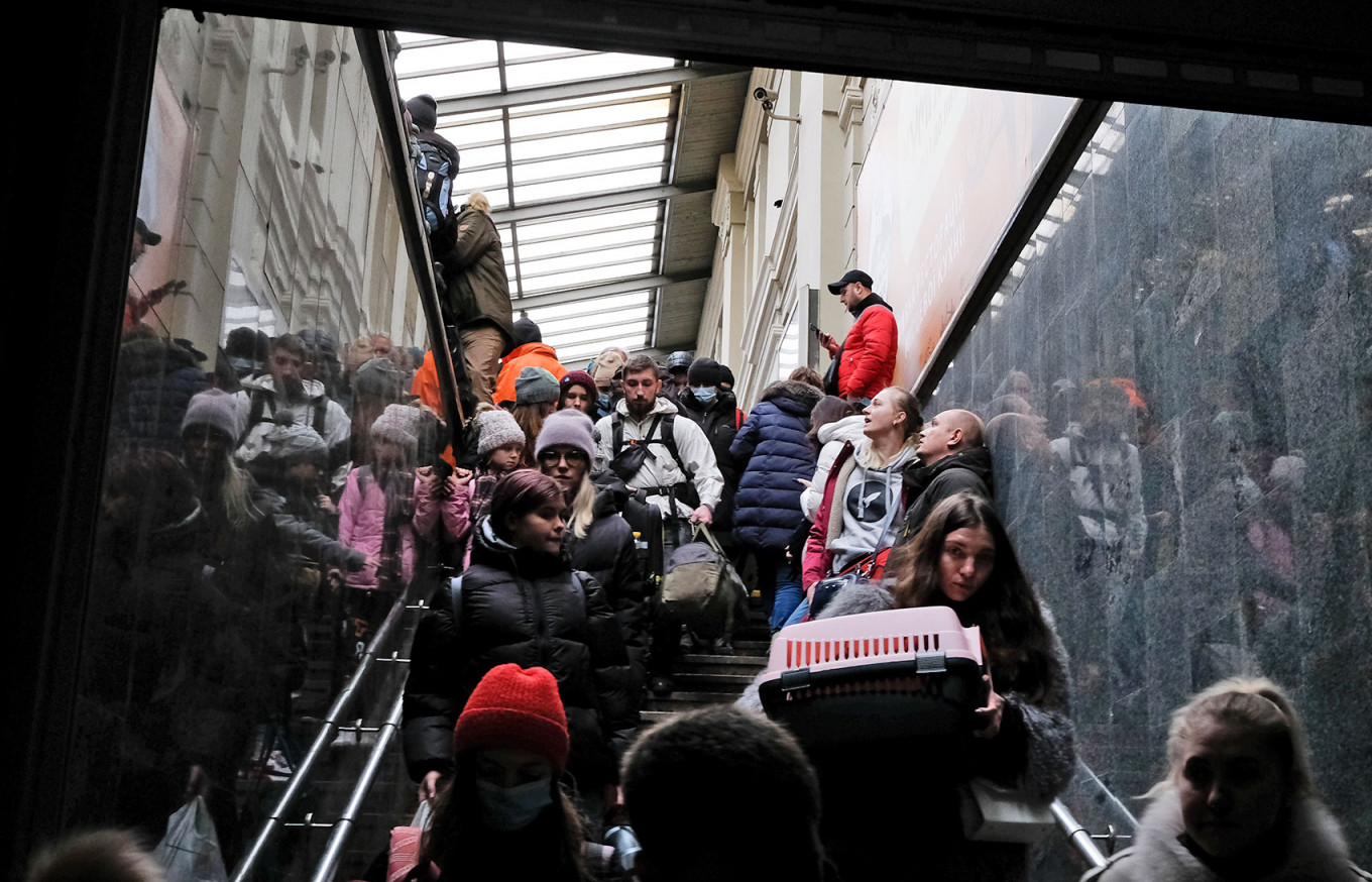 
					People huddle in a station tunnel as an air raid siren sounds.					 					Francis Farrell / MT				