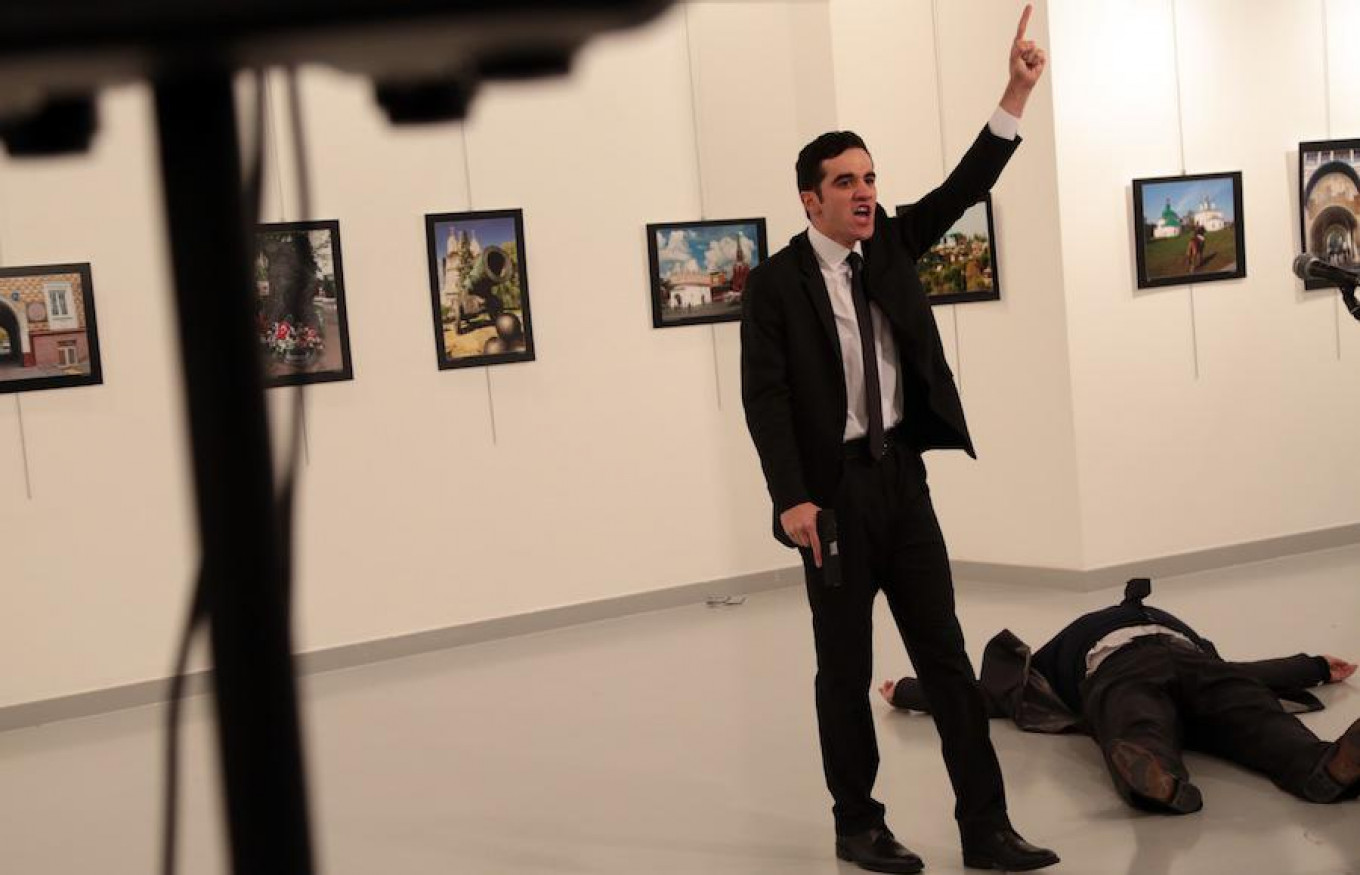 
					A man gestures near to the body of Ambassador Karlov at a photo gallery in Ankara, Turkey, Dec. 19, 2016.					 					Burhan Ozbilici / AP				