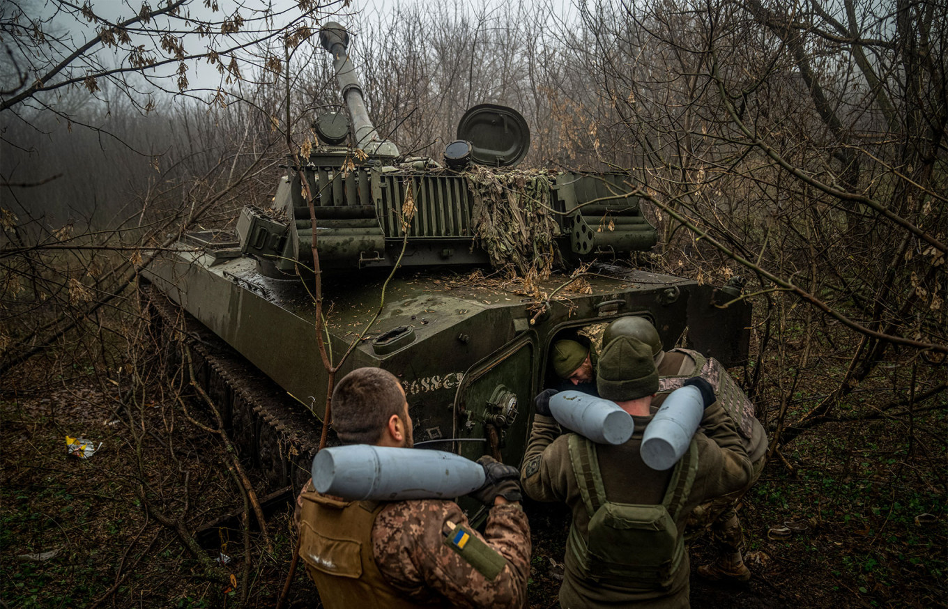 
					Ukrainian artillerymen from the 24th brigade load an ammunition inside of a 2S1 Gvozdika self-propelled howitzer at a position along the front line in the vicinity of Bakhmut, Donetsk region.					 					Ihor Tkachov / AFP				