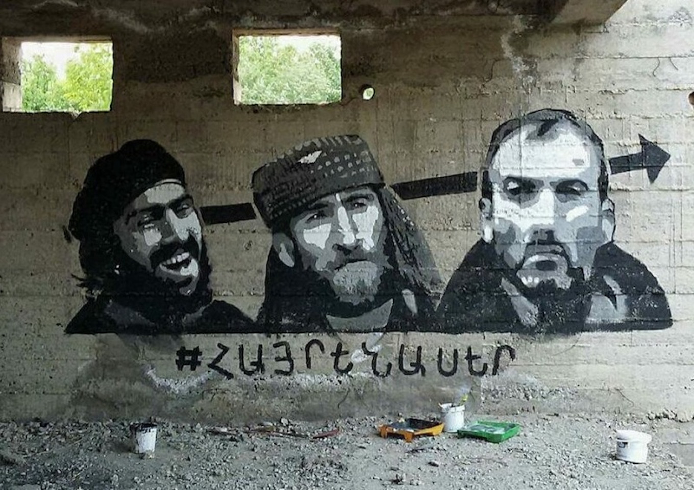 
					Graffiti in the Armenian capital of Yerevan shows three of the Sassoun Daredevil gunmen, with the word ‘Patriot’ written below.					 					Robert Nikoghosyan Art				