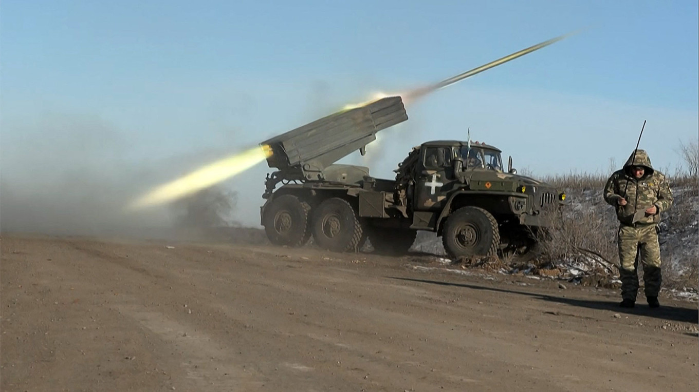 
					A member of Ukraine's military looking away as a BM-21'Grad' MLRS 122mm rocket launcher fires on the outskirts of Soledar on January 11, 2023.					 					Arman Soldin / AFP				