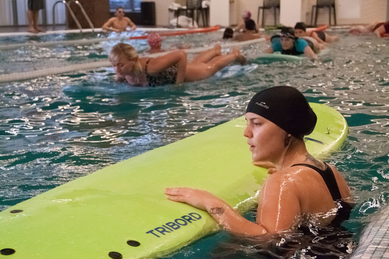 
					Surfers from the Surfway Moscow school get plenty of strange looks when they practice paddling alongside regular swimming pool visitors.					 					Courtesy of Denis Drogaikin				