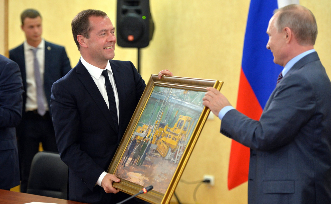 
					Prime Minister Dmitry Medvedev presents Putin with a birthday gift on Sept. 15, 2016.					 					Kremlin Press Service				
