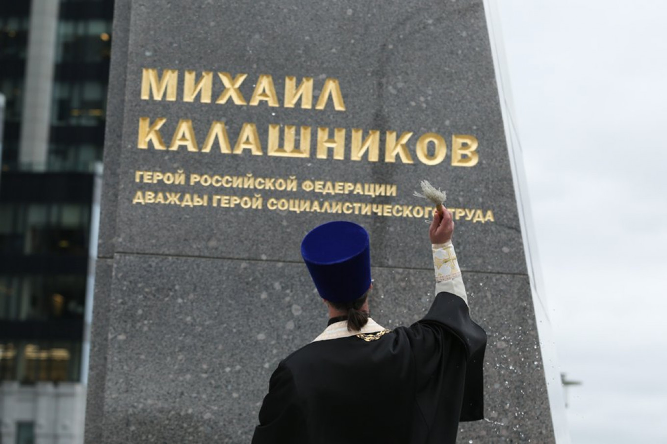 
					A Russian Orthodox priest sprinkles holy water on the new statue of Mikhail Kalashnikov.					 					Kirill Zykov / Moskva News Agency				