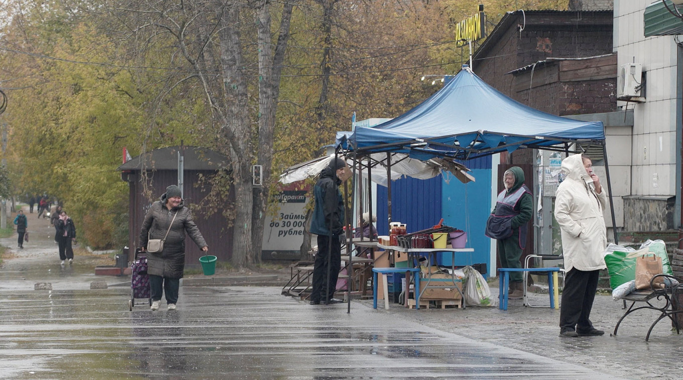 
					A woman walks past a street market in Shelekhov in Russia's Irkutsk region.					 					REUTERS / Stringer				