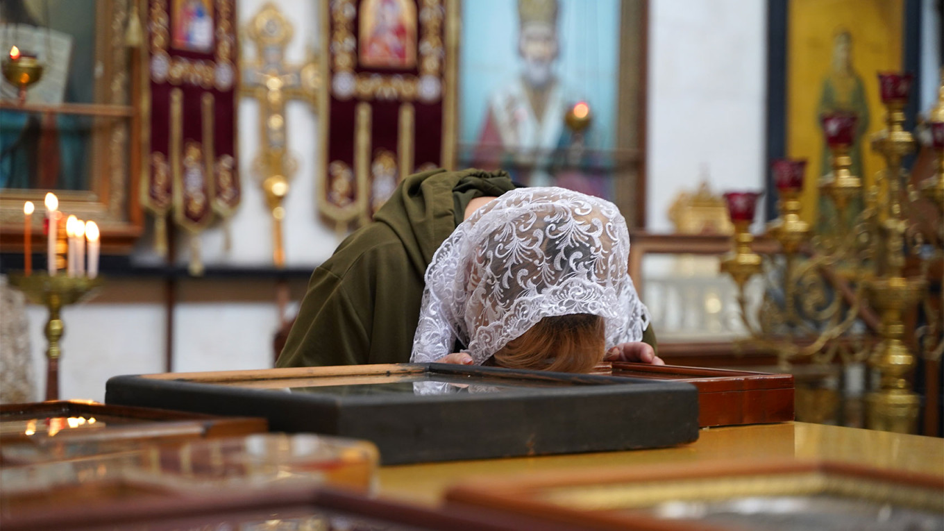 
					A Ukrainian pilgrim prays in the Alexander Nevsky Church. 					 					Iryna Matviyishyn				
