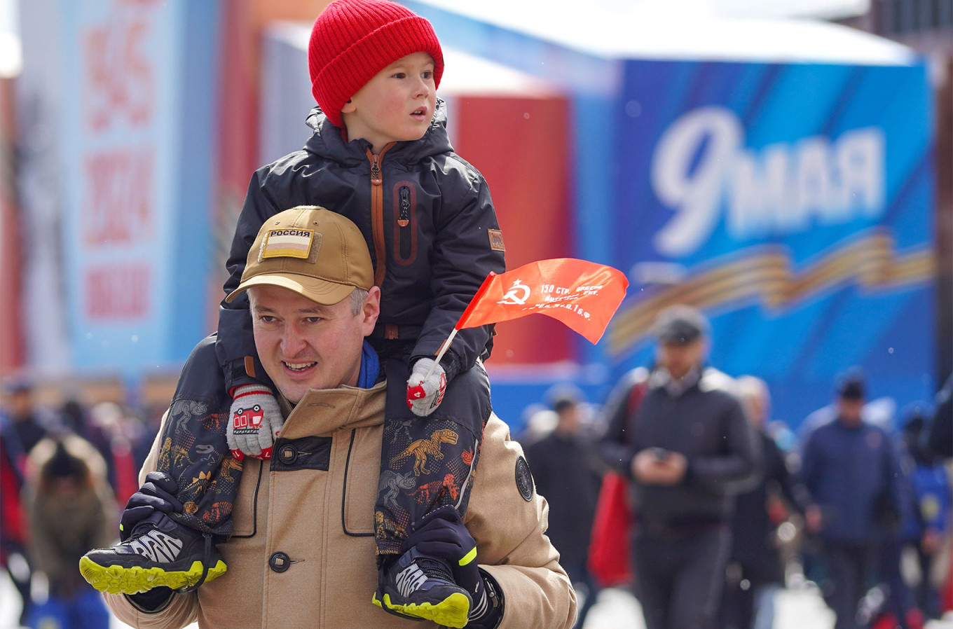 
					A man with a child on May 9 in Moscow.					 					Alexander Avilov / Moskva News Agency				