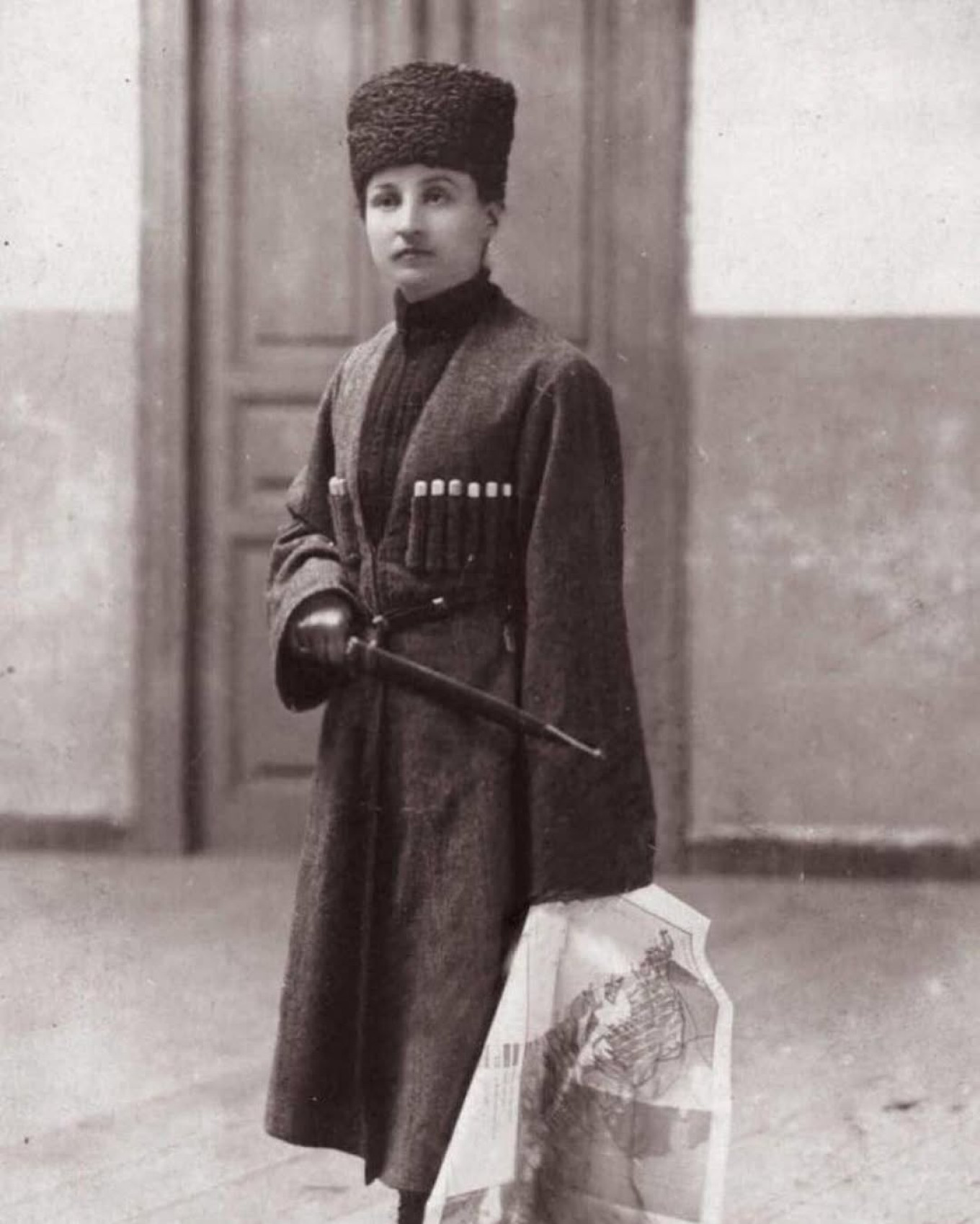A Circassian woman is shown with a map showing the lands to which the Circassians were exiled, 1922. circassian.roots / Instagram