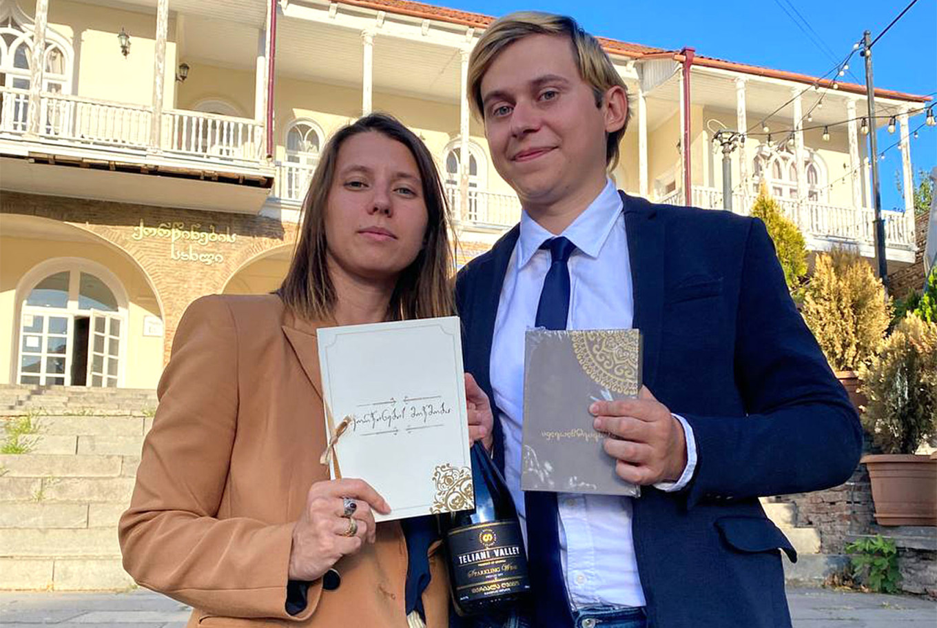 
					Activist Yekaterina Alexandrova and her husband holding Georgian marriage certificates.					 					Courtesy of Yekaterina Alexandrova				