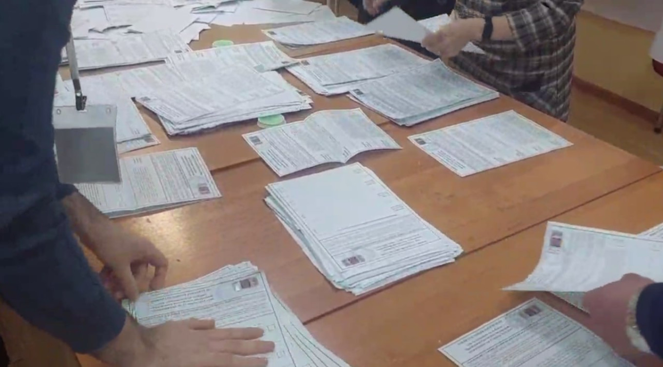 
					Moscow region election officials sort through ballots.					 					Video screenshot / Danil Zimin for MT. 				