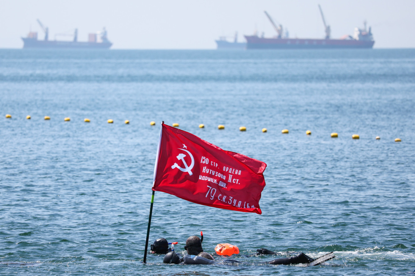 
					Swimmer with a Soviet flag taking part in an event ahead of Victory Day in the port city of Vladivostok. 					 					Yuri Smityuk / ТАСС				