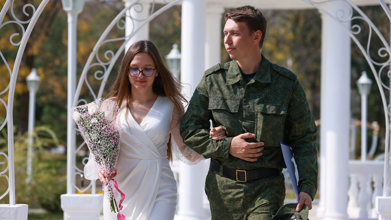 
					
					Newlyweds after a wedding ceremony at a civil registry office in the village of Pokrovka in Russia's Far East.  Yuri Smityuk / TASS				
