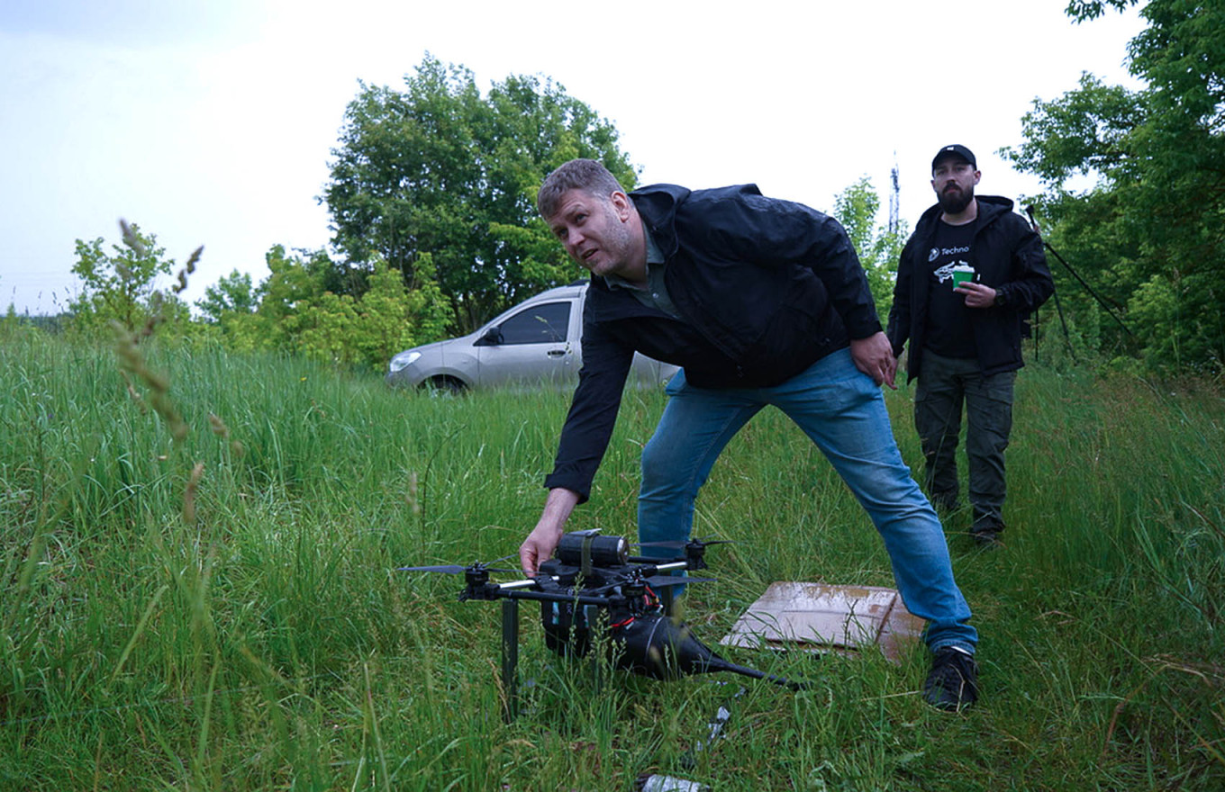 Volodymyr Makhitko, chief engineer at TechnoHawk, is performing final checks before the test flight of the new fiber-optic drone. Joseph Roche