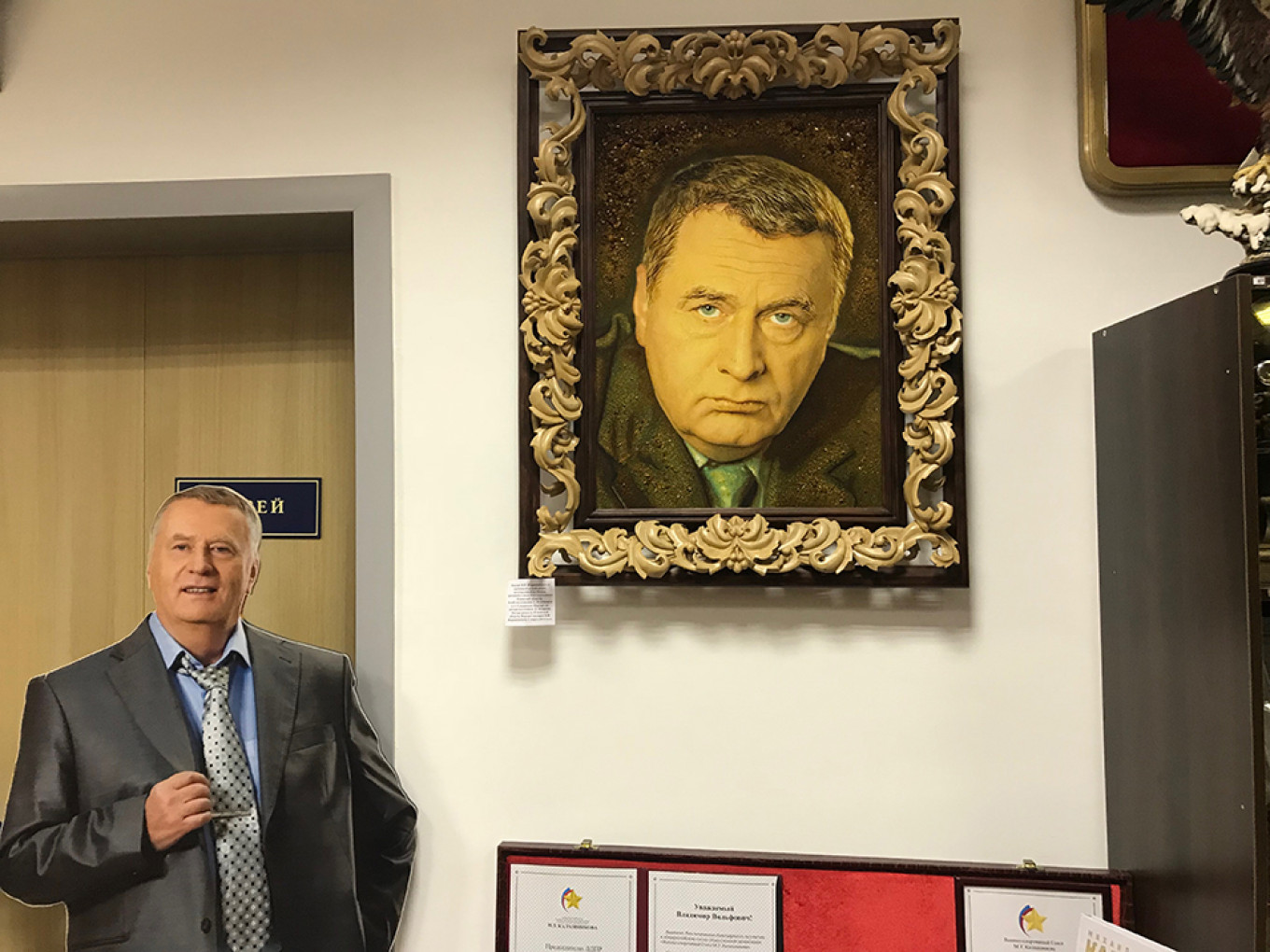 
					A cardboard cutout and portrait of Zhirinovsky at his campaign headquarters					 					Evan Gershkovich				