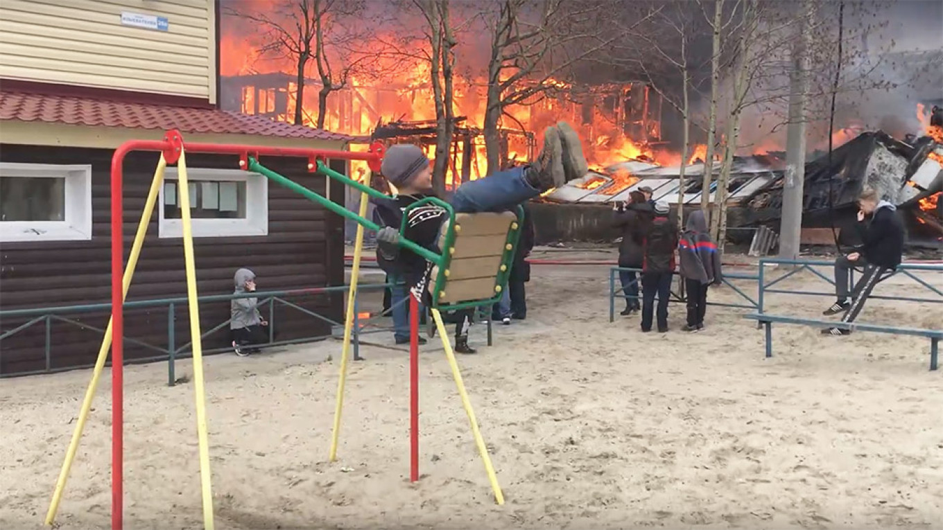 This Is Fine Meme Comes To Life In Rural Russia As Boy Swings Near Raging Fire The Moscow Times