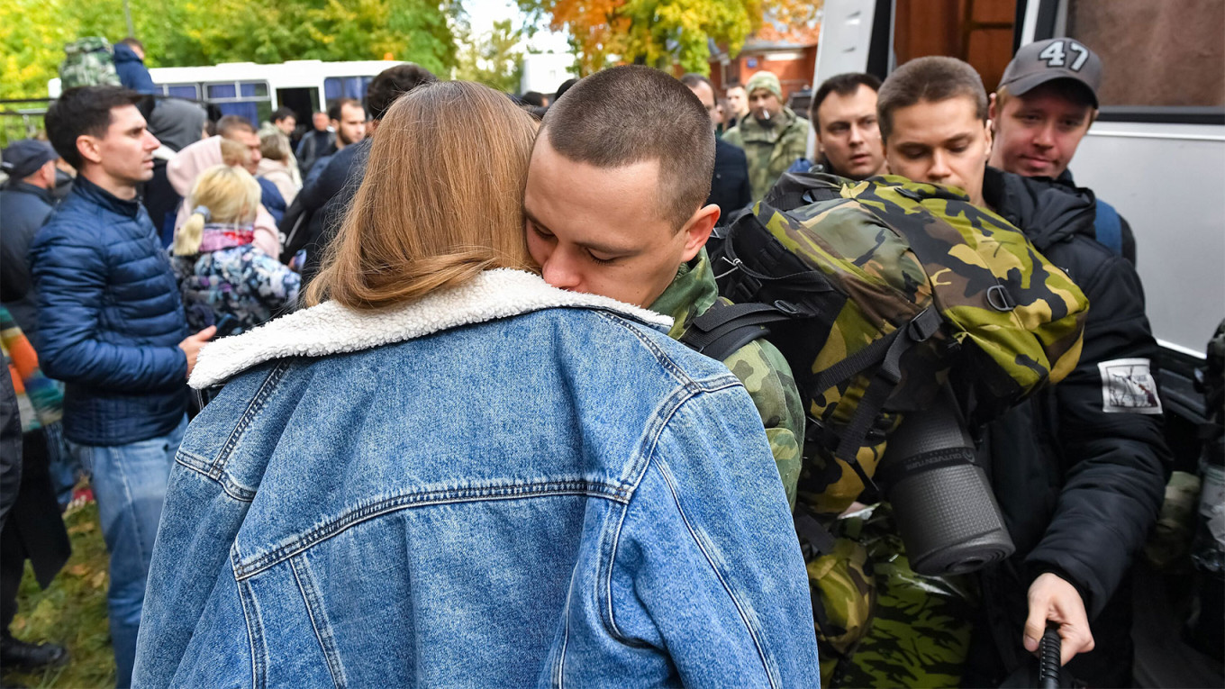 
					Mobilized men at an assembly point in Moscow.					 					Sergei Kiselev / Moskva News Agency				