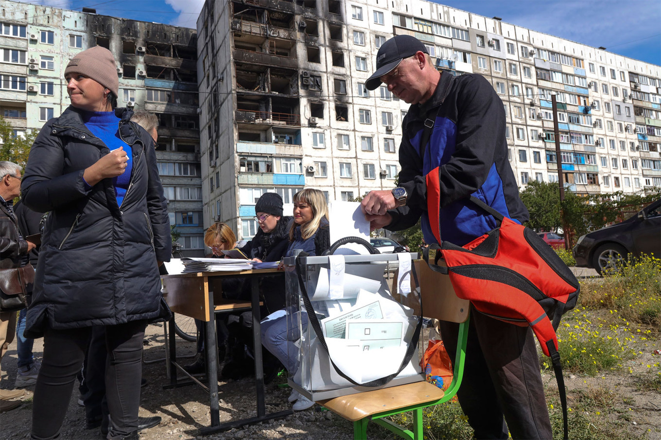 
					People vote at a mobile polling station in the occupied port city of Mariupol.					 					AP Photo / TASS				