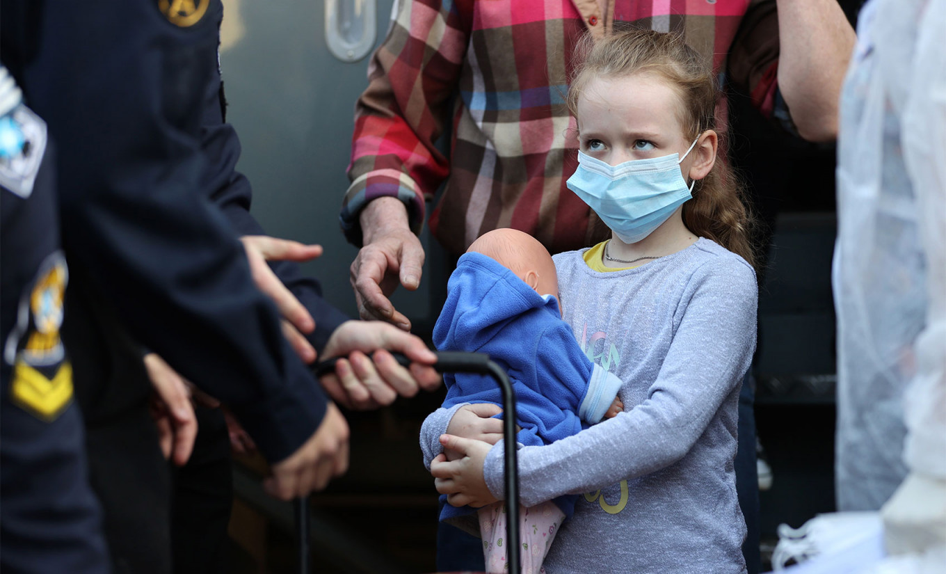 
					A girl disembarks a train carrying displaced residents of Ukraine at a railway station in the port city of Nakhodka, 85km east of Vladivostok.					 					Yuri Smityuk / TASS				