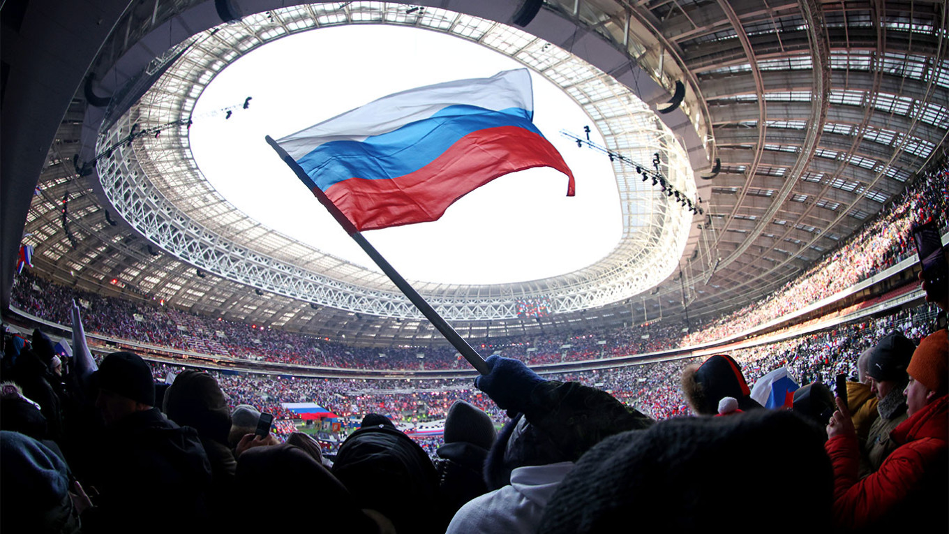 
					Spectators attending the pro-war rally and concert in Moscow's Luzhniki stadium.					 					Sergei Fadeichev / TASS				