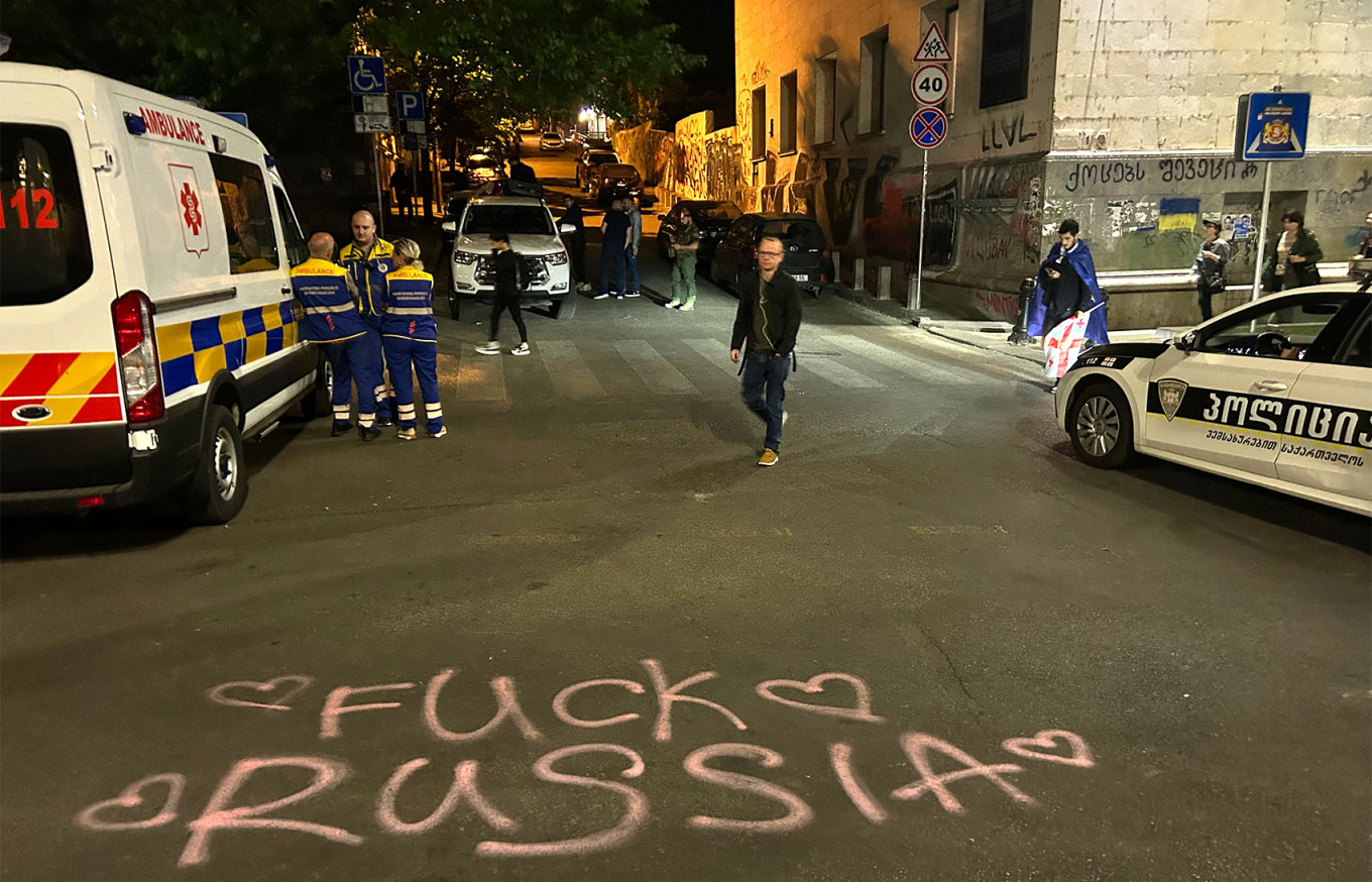 
					People protesting against the “foreign influence” bill spray anti-Russia graffiti on a city street.					 					MT				