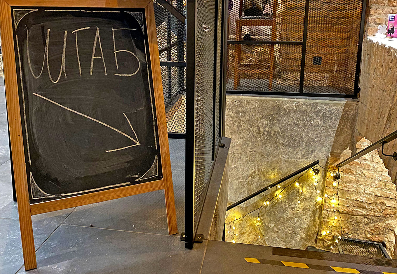 
					A sign pointing to the basement of Not Only Coffee reads "headquarters."					 					Lukas Žalalis				