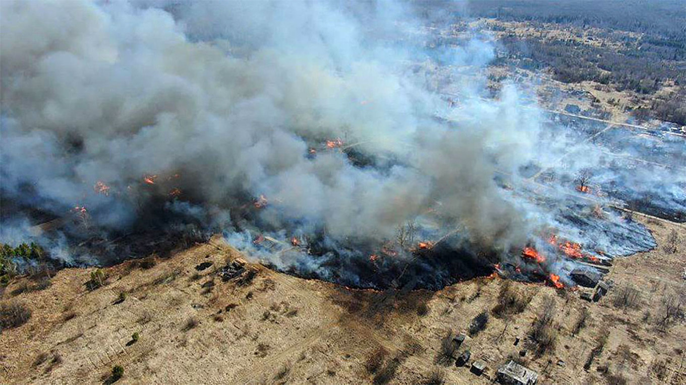 
					Smoke rises from a fire in the village of Sosva where almost 100 buildings burned down.					 					Russian National Guard Press Service				