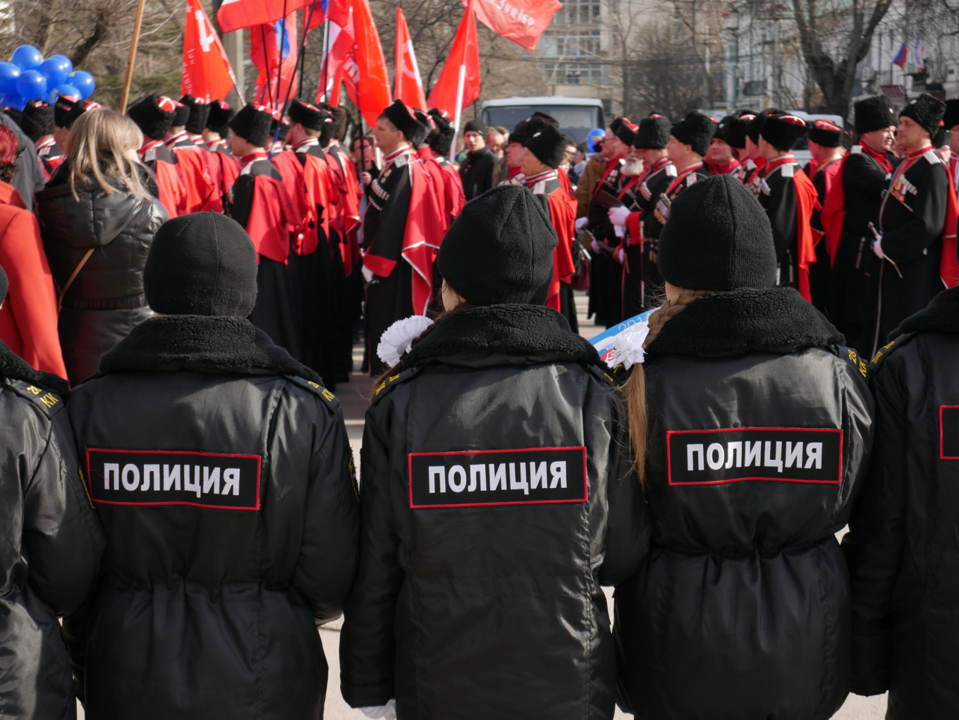 
					Young children dressed in police uniforms watch over the proceedings.					 					The Moscow Times				