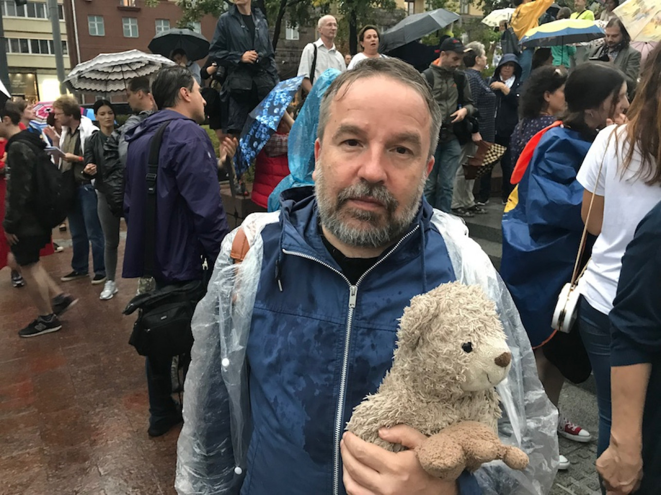 
					Oleg Lekmanov, 51, a literature professor at the Higher School of Economics, brought his wife’s childhood teddy bear to the march. 					 					Evan Gershkovich for MT				