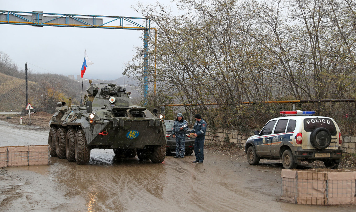 
					Russian peacekeepers' military hardware and a police car at an outpost in the city of Stepanakert, Nagorno-Karabakh.					 					Alexander Ryumin / TASS				