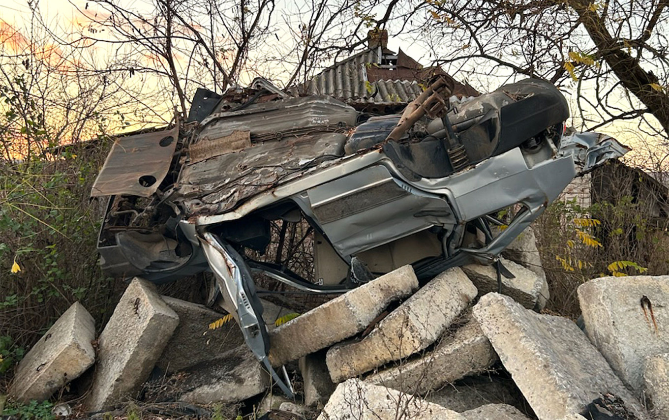 
					A destroyed car on its roof on the side of the road in Kam’yanka.					 					Joshua Robert Kroeker				