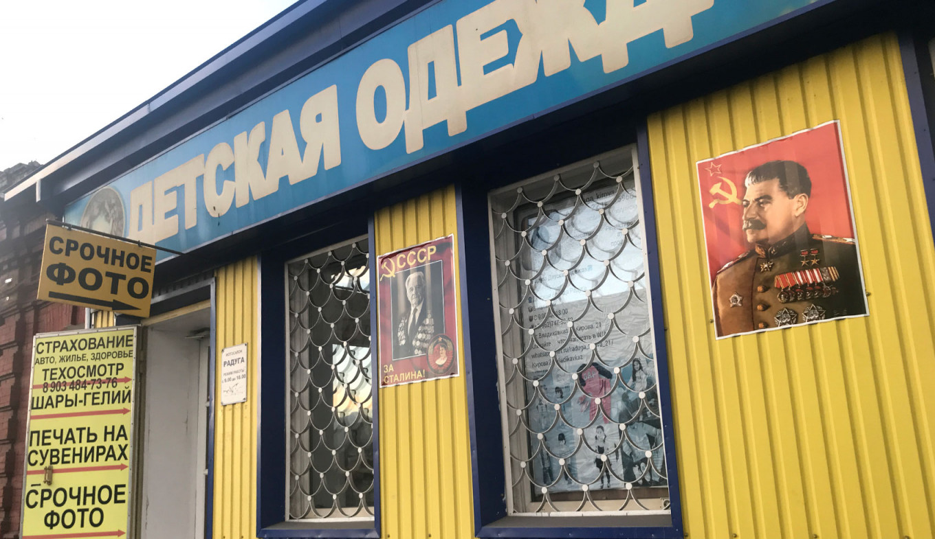 
					Stalin's portrait hangs outside a Vladikavkaz children's clothing store.					 					Felix Light / MT				