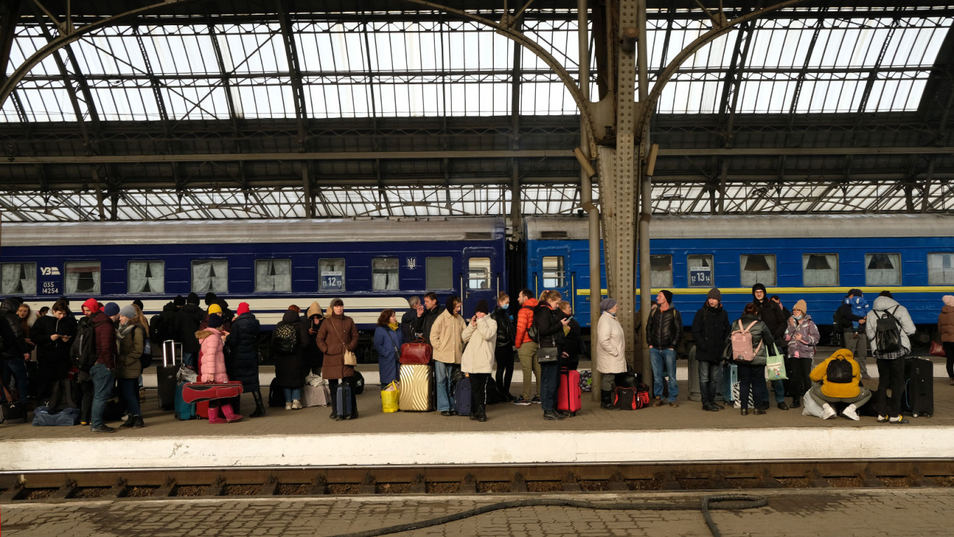 
					Refugees wait for a train to take them across the border to Poland.					 					Francis Farrell / MT				