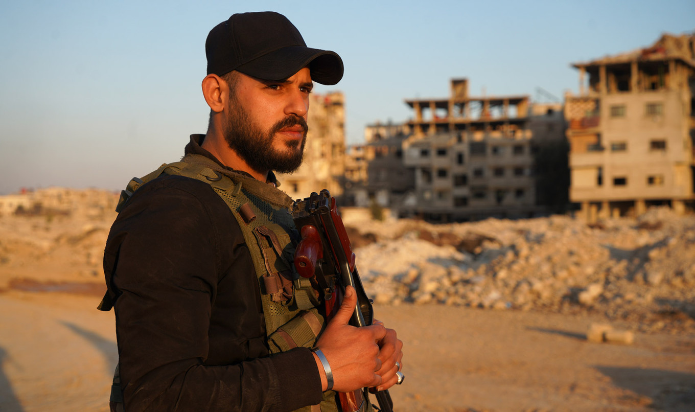 
					HTS fighter Abdul Rahman, 24, standing on the former front line in the Jobar district of Damascus, Jan. 7, 2025.					 					Iryna Matviyishyn				